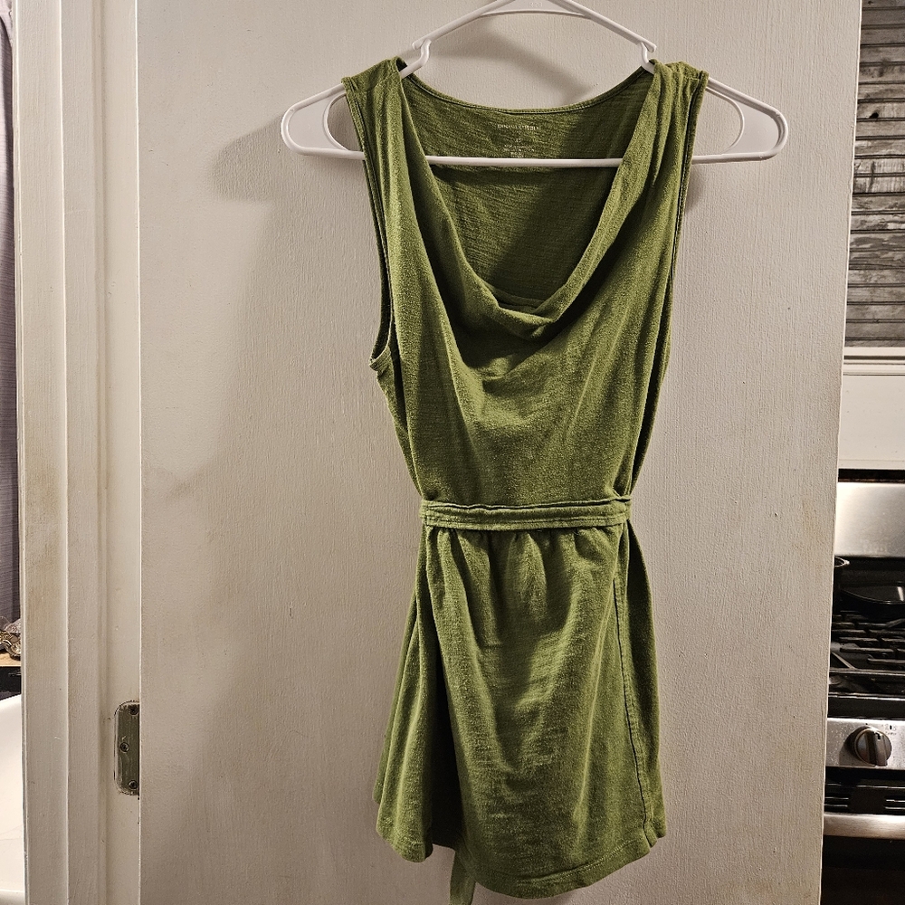 Green sleeveless women's blouse with tie in the back.